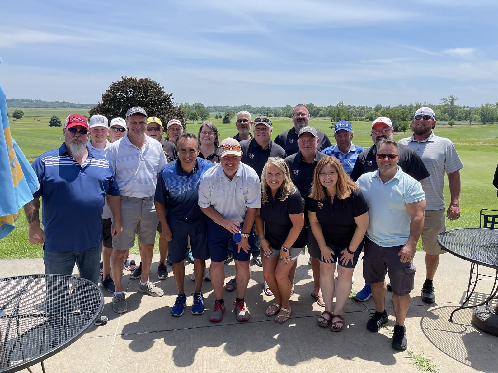 Golf scramble participants standing between golf carts at Eagle Hills Golf Course