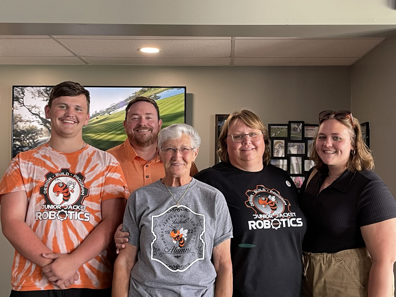 Golf scramble participants standing between golf carts at Eagle Hills Golf Course